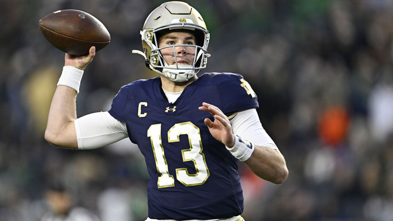 SOUTH BEND, INDIANA - NOVEMBER 16: Riley Leonard #13 of the Notre Dame Fighting Irish throws a touchdown in the first half against the Virginia Cavaliers at Notre Dame Stadium on November 16, 2024 in South Bend, Indiana.