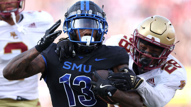 DALLAS, TEXAS - NOVEMBER 16: Roderick Daniels Jr. #13 of the Southern Methodist Mustangs is tackled by Carter Davis #28 of the Boston College Eagles during the first half at Gerald J. Ford Stadium on November 16, 2024 in Dallas, Texas.