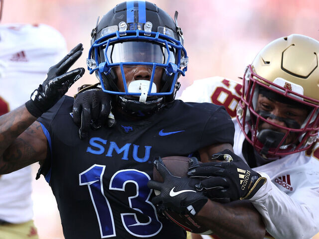 DALLAS, TEXAS - NOVEMBER 16: Roderick Daniels Jr. #13 of the Southern Methodist Mustangs is tackled by Carter Davis #28 of the Boston College Eagles during the first half at Gerald J. Ford Stadium on November 16, 2024 in Dallas, Texas.
