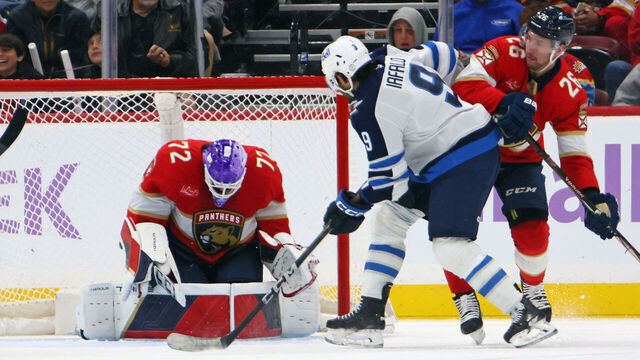 SUNRISE, FLORIDA - NOVEMBER 16: Skating in his 100th NHL game, Alex Iafallo #9 of the Winnipeg Jets is stopped by Sergei Bobrovsky #72 of the Florida Panthers at Amerant Bank Arena on November 16, 2024 in Sunrise, Florida.