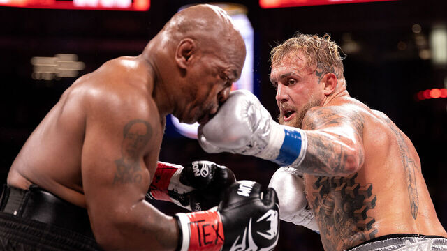 ARLINGTON, TEXAS - NOVEMBER 15: Jake Paul punches Mike Tyson during LIVE On Netflix: Jake Paul vs. Mike Tyson at AT&T Stadium on November 15, 2024 in Arlington, Texas.