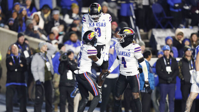 PROVO, UT - NOVEMBER 16: Mello Dotson #3 of the Kansas Jayhawks celebrates an interception with teammates Cobee Bryant #2 and Marvin Grant #4 during the first half of their game agianst the Brigham Young Cougars at LaVell Edwards Stadium on November 16, 2024 in Provo, Utah.