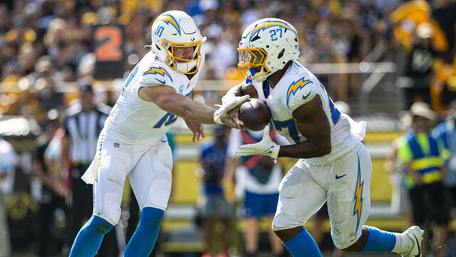 PITTSBURGH, PA - SEPTEMBER 22: Los Angeles Chargers quarterback Justin Herbert (10) hands the ball off to Los Angeles Chargers running back J.K. Dobbins (27) during the regular season NFL football game between the Los Angeles Chargers and Pittsburgh Steelers on September 22, 2024 at Acrisure Stadium in Pittsburgh, PA.