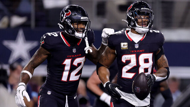 ARLINGTON, TEXAS - NOVEMBER 18: Joe Mixon #28 of the Houston Texans celebrates with Nico Collins #12 after scoring a touchdown against the Dallas Cowboys during the first quarter in the game at AT&T Stadium on November 18, 2024 in Arlington, Texas.
