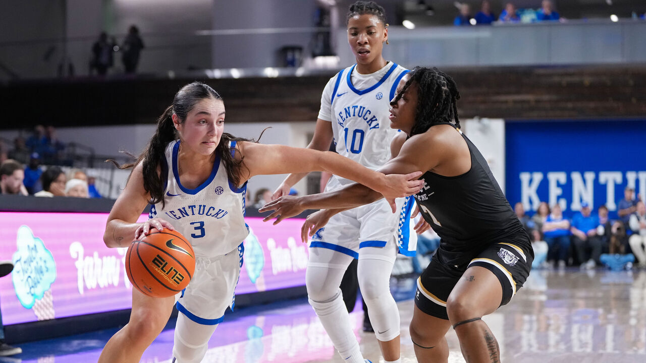 LEXINGTON, KENTUCKY - NOVEMBER 18: Georgia Amoore #3 of the Kentucky Wildcats drives against Tia Morgan #7 of the Purdue Fort Wayne Mastodons in the third quarter at the Memorial Coliseum on November 18, 2024 in Lexington, Kentucky.
