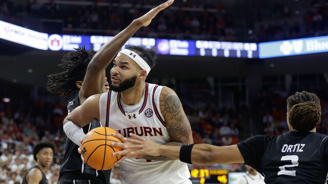 AUBURN, ALABAMA - NOVEMBER 18: Johni Broome #4 of the Auburn Tigers drives to the basket as Israel Jenrette #21 of the North Alabama Lions defends during the second half of at Neville Arena on November 18, 2024 in Auburn, Alabama.