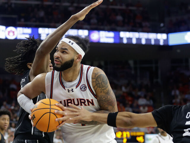 AUBURN, ALABAMA - NOVEMBER 18: Johni Broome #4 of the Auburn Tigers drives to the basket as Israel Jenrette #21 of the North Alabama Lions defends during the second half of at Neville Arena on November 18, 2024 in Auburn, Alabama.