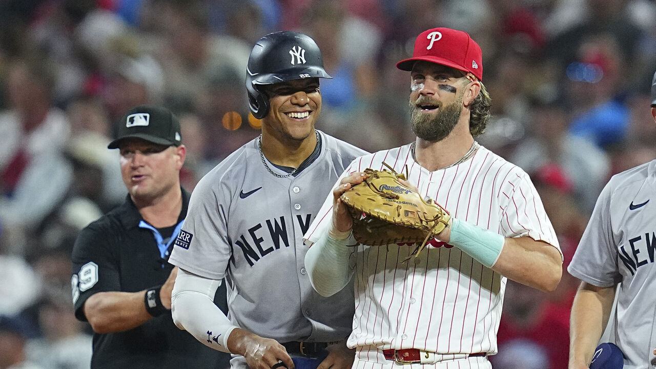 PHILADELPHIA, PENNSYLVANIA - JULY 29: Juan Soto #22 of the New York Yankees interacts with Bryce Harper #3 of the Philadelphia Phillies at Citizens Bank Park on July 29, 2024 in Philadelphia, Pennsylvania. The Yankees defeated the Phillies 14-4.