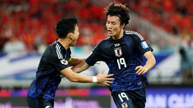 XIAMEN, CHINA - NOVEMBER 19: Koki Ogawa (R) of Japan celebrates with Wataru Endo after scoring the team's first goal against China in the first half during the FIFA World Cup Asian 3rd Qualifier Group C match on November 19, 2024 in Xiamen, China.