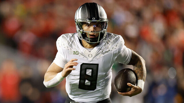 MADISON, WISCONSIN - NOVEMBER 16: Dillon Gabriel #8 of the Oregon Ducks runs with the ball for a first down late in the game against the Wisconsin Badgers at Camp Randall Stadium on November 16, 2024 in Madison, Wisconsin.