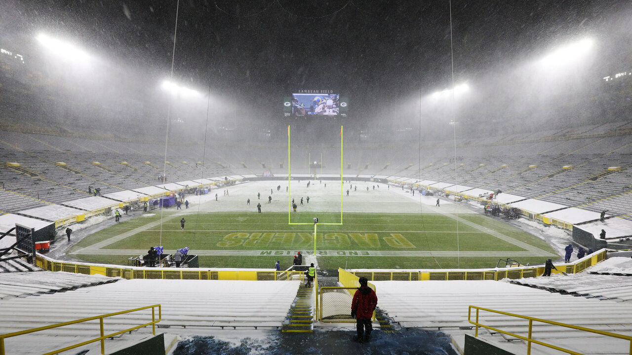 GREEN BAY, WISCONSIN - DECEMBER 27: Snow falls during warmups between the Green Bay Packers and the Tennessee Titans at Lambeau Field on December 27, 2020 in Green Bay, Wisconsin.