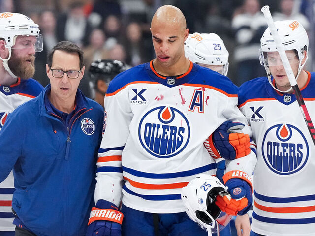 TORONTO, CANADA - NOVEMBER 16: Darnell Nurse #25 of the Edmonton Oilers is helped off the ice following a hit from Ryan Reaves #75 of the Toronto Maple Leafs at Scotiabank Arena on November 16, 2024 in Toronto, Ontario, Canada.