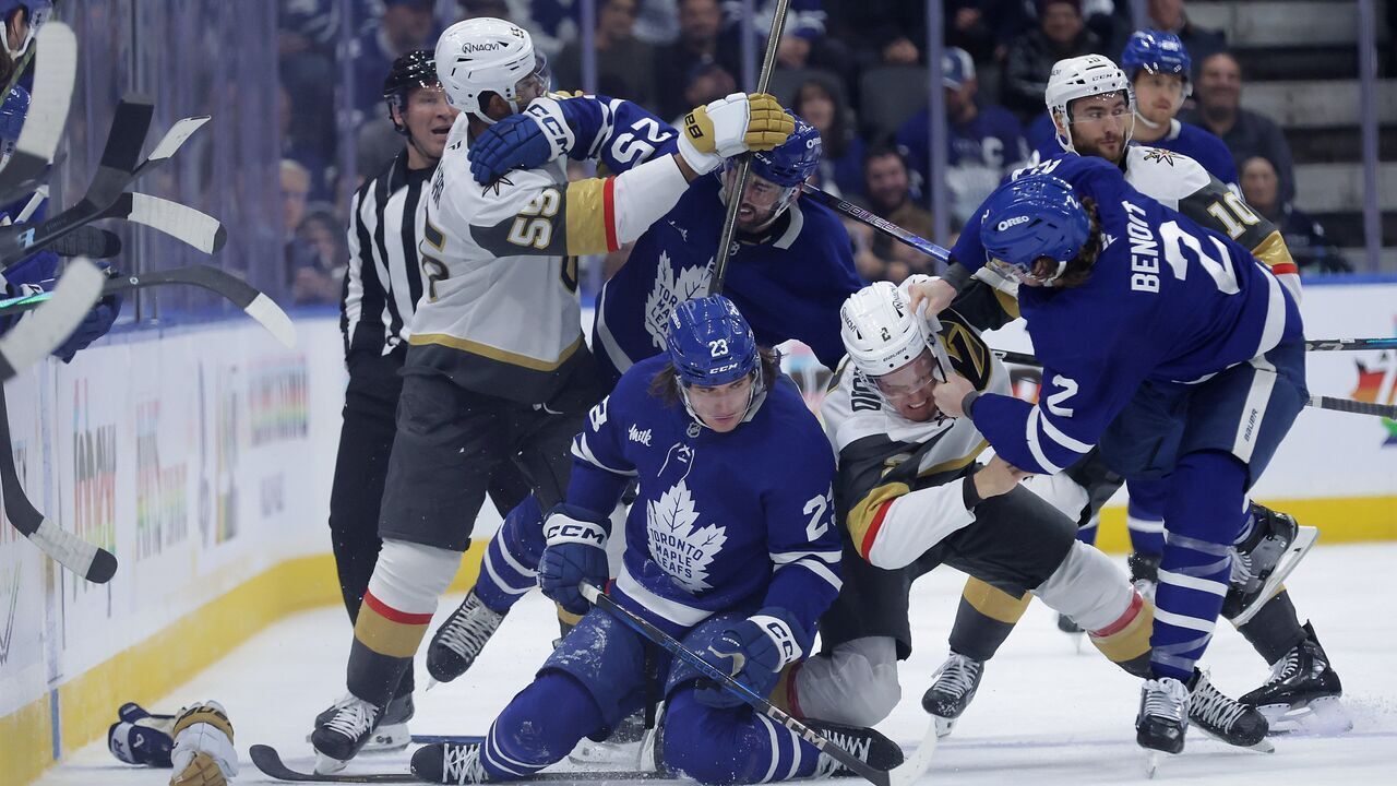 TORONTO, ON- NOVEMBER 20 - Toronto Maple Leafs left wing Matthew Knies (23) lays on the ice after getting checked by Vegas Golden Knights defenseman Zach Whitecloud (2) as Toronto Maple Leafs defenseman Simon Benoit (2) steps in and Vegas Golden Knights right wing Keegan Kolesar (55) and Toronto Maple Leafs defenseman Conor Timmins (25) tangle in second period action as the Toronto Maple Leafs play the Vegas Golden Knights at Scotiabank Arena in Toronto. November 20, 2024.