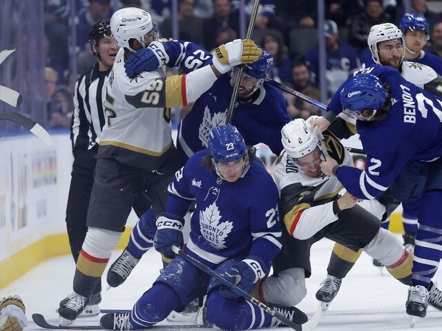 TORONTO, ON- NOVEMBER 20 - Toronto Maple Leafs left wing Matthew Knies (23) lays on the ice after getting checked by Vegas Golden Knights defenseman Zach Whitecloud (2) as Toronto Maple Leafs defenseman Simon Benoit (2) steps in and Vegas Golden Knights right wing Keegan Kolesar (55) and Toronto Maple Leafs defenseman Conor Timmins (25) tangle in second period action as the Toronto Maple Leafs play the Vegas Golden Knights at Scotiabank Arena in Toronto. November 20, 2024.