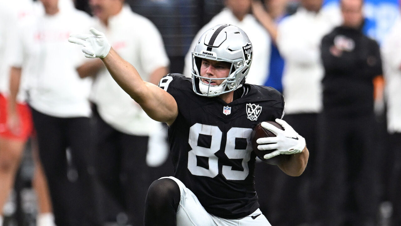 LAS VEGAS, NEVADA - OCTOBER 27: Brock Bowers #89 of the Las Vegas Raiders signals for a first down after a making a catch against Nazeeh Johnson #13 of the Kansas City Chiefs in the second quarter of a game at Allegiant Stadium on October 27, 2024 in Las Vegas, Nevada.