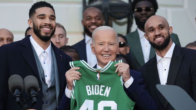 WASHINGTON, DC - NOVEMBER 21: U.S. President Joe Biden holds up a jersey presented to him by Boston Celtics players Jayson Tatum (L) and Derrick White (R) as he welcomed the 2024 NBA Champion Boston Celtics to the White House November 21, 2024 in Washington, DC. The Celtics beat the Dallas Mavericks 4 games to 1 to win the championship.