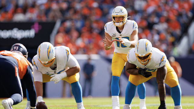 DENVER, COLORADO - OCTOBER 13: Quarterback Justin Herbert #10 of the Los Angeles Chargers gets set during the first quarter of an NFL football game against the Denver Broncos at Empower Field at Mile High on October 13, 2024 in Denver, Colorado.