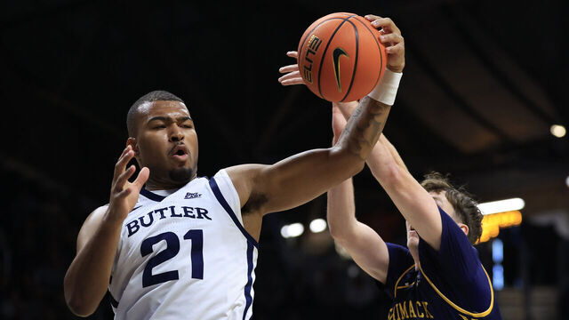 INDIANAPOLIS, INDIANA - NOVEMBER 22: Pierre Brooks II #21 of the Butler Bulldogs rebounds the ball against Matt Becht #3 of the Merrimack Warriors during the first half at Hinkle Fieldhouse on November 22, 2024 in Indianapolis, Indiana.