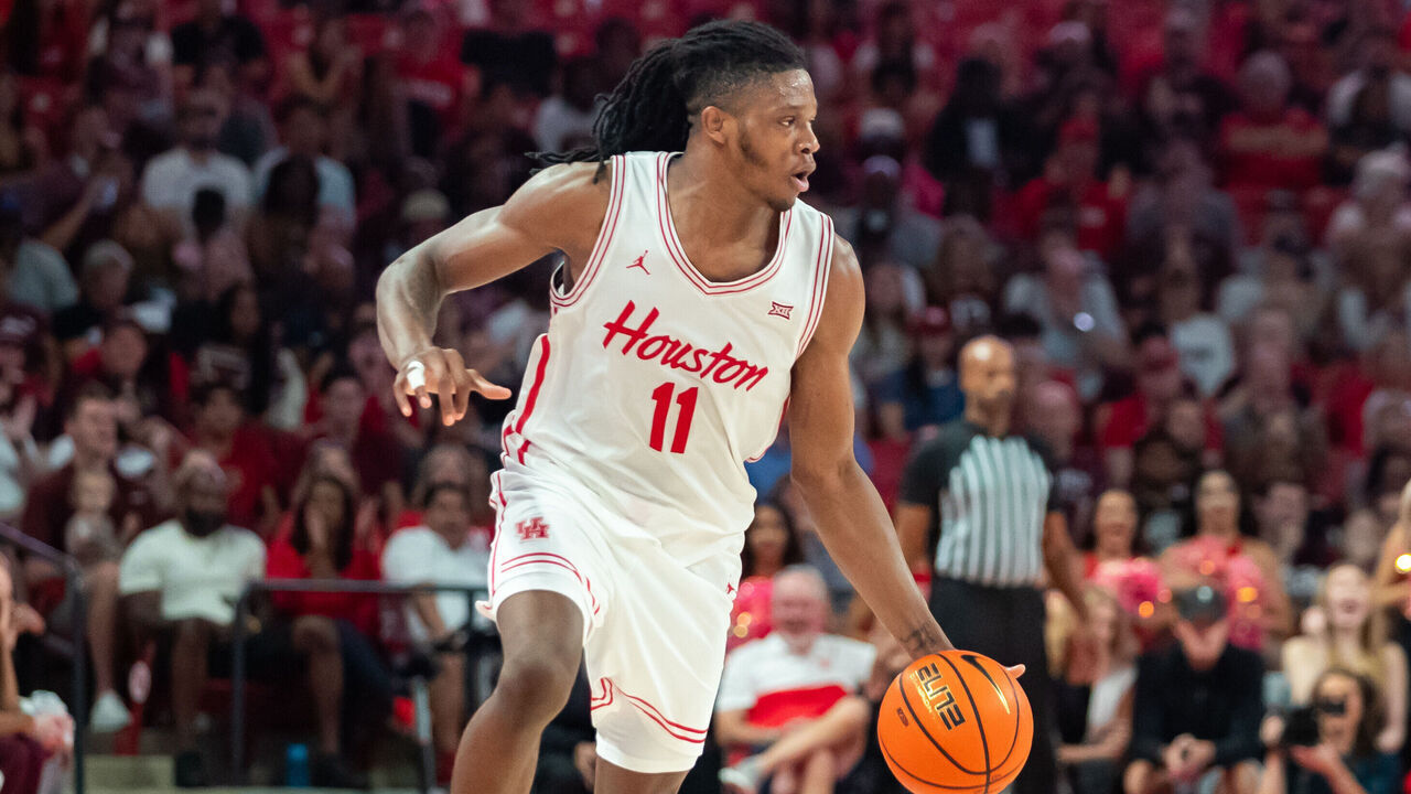 HOUSTON, TEXAS - OCTOBER 27: Joseph Tugler #11 of the Houston Cougars dribbles the ball near midcourt during a game against the Texas A&M Aggies at Fertitta Center on October 27, 2024 in Houston, Texas.