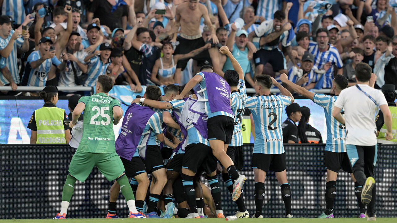 Racing players celebrate with fans after winning the Copa Sudamericana final football match between Argentina's Racing and Brazil's Cruzeiro at La Nueva Olla Stadium in Asuncion on November 23, 2024.