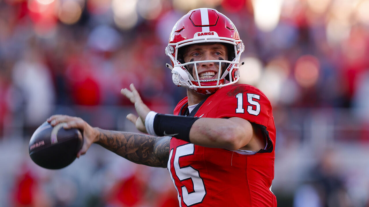 ATHENS, GEORGIA - NOVEMBER 23: Carson Beck #15 of the Georgia Bulldogs throws on the sideline before taking the field during the third quarter against the Massachusetts Minutemen at Sanford Stadium on November 23, 2024 in Athens, Georgia.