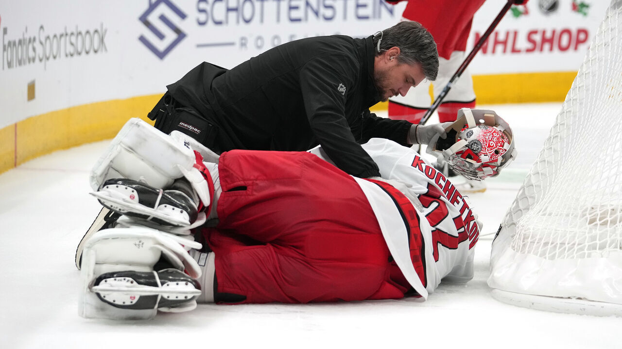 COLUMBUS, OHIO - NOVEMBER 23: Pyotr Kochetkov #52 of the Carolina Hurricanes is attend to by training staff after a collision during overtime against the Columbus Blue Jackets at Nationwide Arena on November 23, 2024 in Columbus, Ohio.