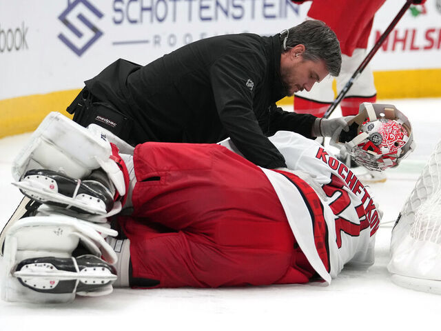 COLUMBUS, OHIO - NOVEMBER 23: Pyotr Kochetkov #52 of the Carolina Hurricanes is attend to by training staff after a collision during overtime against the Columbus Blue Jackets at Nationwide Arena on November 23, 2024 in Columbus, Ohio.