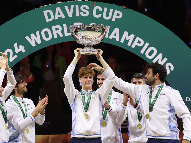 Italy's Jannik Sinner raises the trophy with teammates after winning the Davis Cup Finals at the Palacio de Deportes Jose Maria Martin Carpena arena in Malaga, southern Spain, on November 24, 2024.