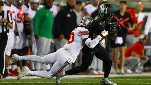 EUGENE, OREGON - OCTOBER 12: Evan Stewart #7 of the Oregon Ducks runs after the catch in front of Denzel Burke #10 of the Ohio State Buckeyes during the second half at Autzen Stadium on October 12, 2024 in Eugene, Oregon.
