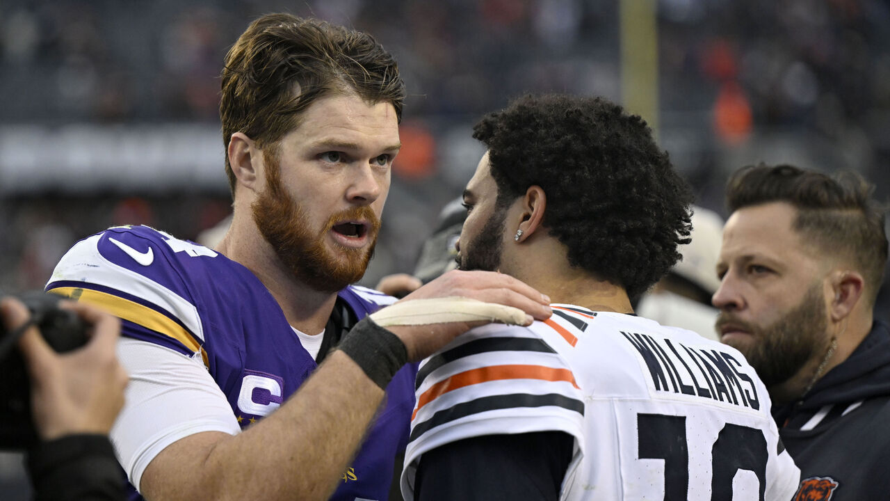CHICAGO, ILLINOIS - NOVEMBER 24: Sam Darnold #14 of the Minnesota Vikings talks with Caleb Williams #18 of the Chicago Bears after their game at Soldier Field on November 24, 2024 in Chicago, Illinois.