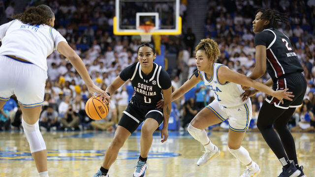 LOS ANGELES, CALIFORNIA - NOVEMBER 24: Te-Hina Paopao #0 of the South Carolina Gamecocks moves the ball past Kiki Rice #1 of the UCLA Bruins in the second quarter at UCLA Pauley Pavilion on November 24, 2024 in Los Angeles, California.
