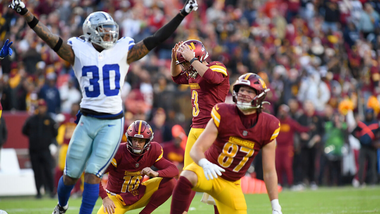LANDOVER, MD - NOVEMBER 24: Commanders kicker Austin Seibert (3) reacts after missing an extra point late in the fourth quarter as Cowboys safety Juanyeh Thomas (30) celebrates during the Dallas Cowboys versus Washington Commanders National Football League game at Northwest Stadium on November 24, 2024 in Landover, MD.