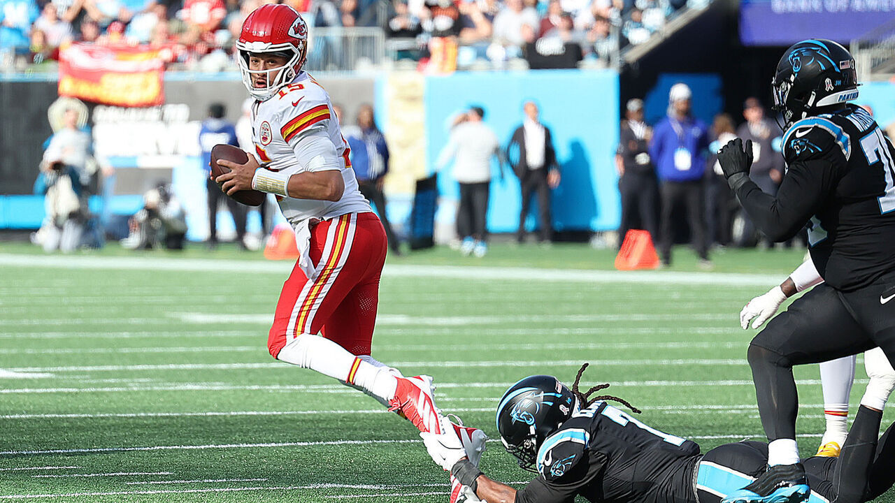 CHARLOTTE, NC - NOVEMBER 24: Kansas City Chiefs quarterback Patrick Mahomes (15) is tripped up for a tackle by Carolina Panthers outside linebacker Jadeveon Clowney (7) during an NFL football game between the Kansas City Chiefs and the Carolina Panthers on November 24, 2024 at Bank of America Stadium in Charlotte, N.C.