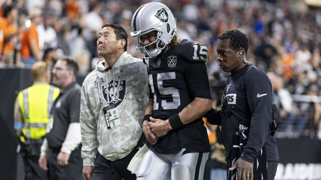 LAS VEGAS, NEVADA - NOVEMBER 24: Gardner Minshew #15 of the Las Vegas Raiders reacts to an apparent injury as he’s helped off the field during an NFL Football game against the Denver Broncos at Allegiant Stadium on November 24, 2024 in Las Vegas, Nevada.