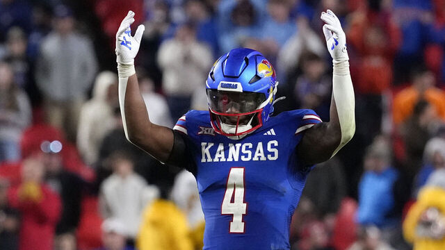 KANSAS CITY, MISSOURI - NOVEMBER 23: With time running down in the game, running back Devin Neal #4 of the Kansas Jayhawks starts to celebrate in the second half against the Colorado Buffaloes at Arrowhead Stadium on November 23, 2024 in Kansas City, Missouri. The Jayhawks won 37-21.