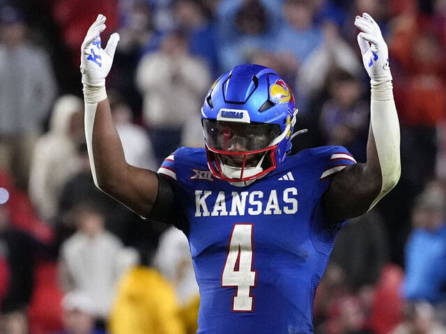 KANSAS CITY, MISSOURI - NOVEMBER 23: With time running down in the game, running back Devin Neal #4 of the Kansas Jayhawks starts to celebrate in the second half against the Colorado Buffaloes at Arrowhead Stadium on November 23, 2024 in Kansas City, Missouri. The Jayhawks won 37-21.