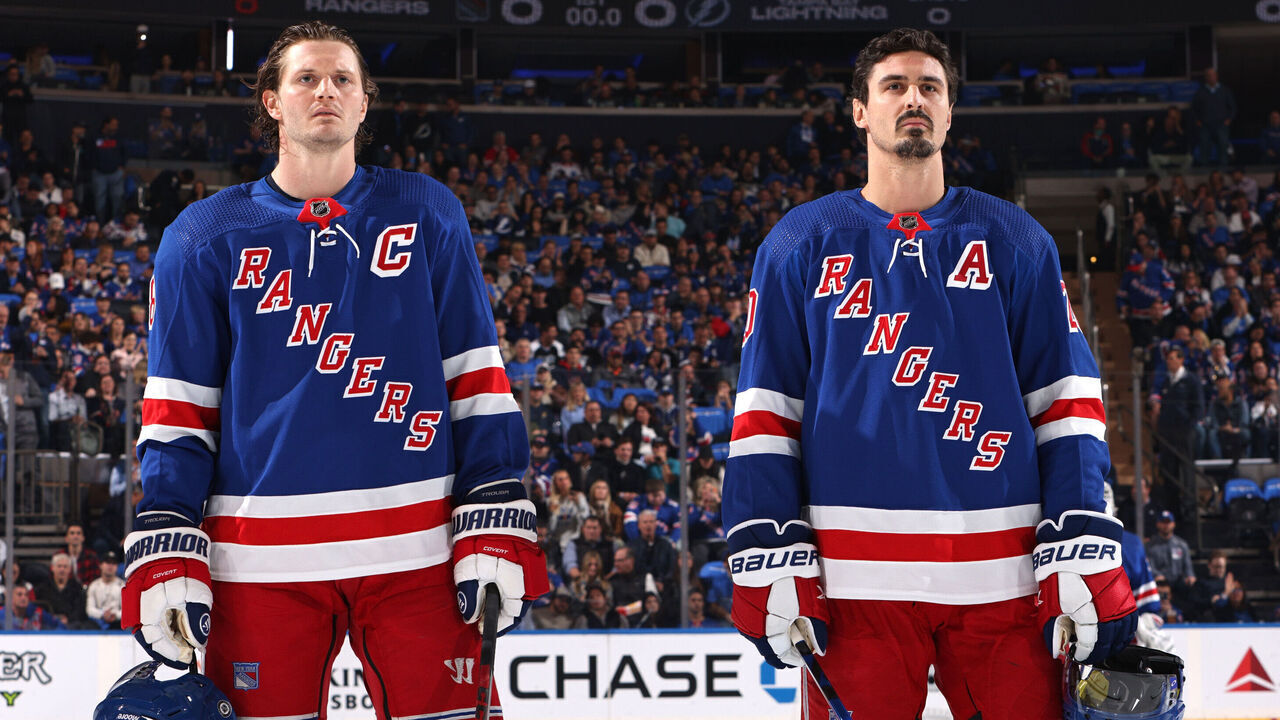 NEW YORK, NEW YORK - OCTOBER 11: Jacob Trouba #8 and Chris Kreider #20 of the New York Rangers look on during the national anthem prior to the home opener against the Tampa Bay Lightning at Madison Square Garden on October 11, 2022 in New York City.