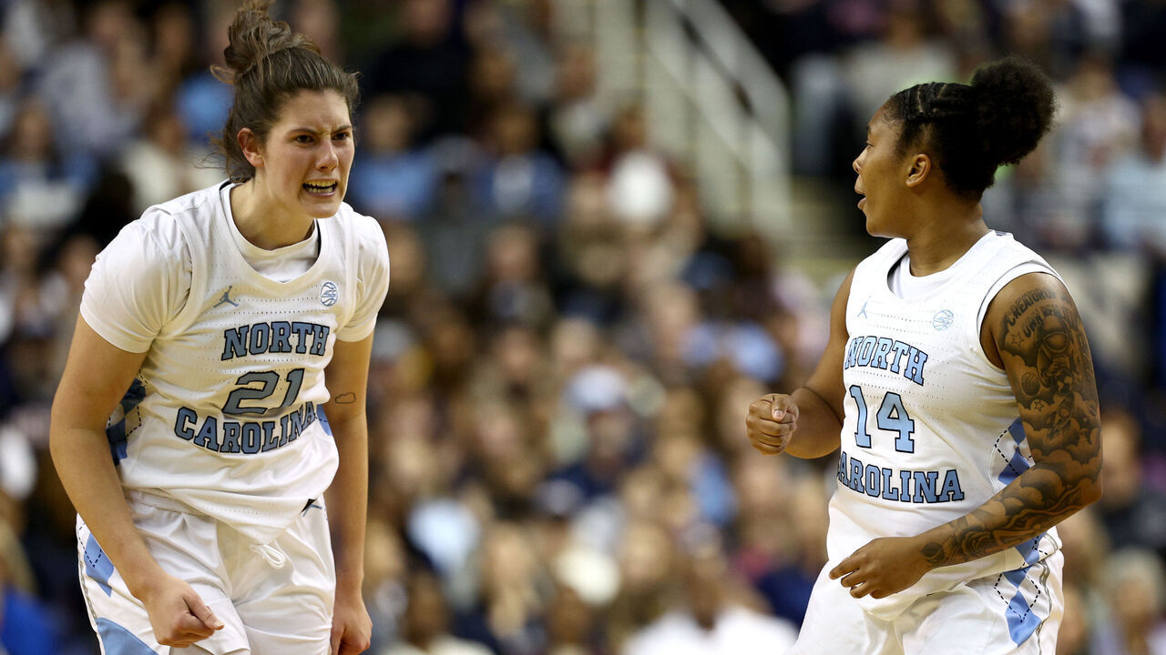 GREENSBORO, NORTH CAROLINA - NOVEMBER 15: Ciera Toomey #21 and Trayanna Crisp #14 of the North Carolina Tar Heels react during the second half of the game against the UConn Huskies at First Horizon Coliseum on November 15, 2024 in Greensboro, North Carolina.