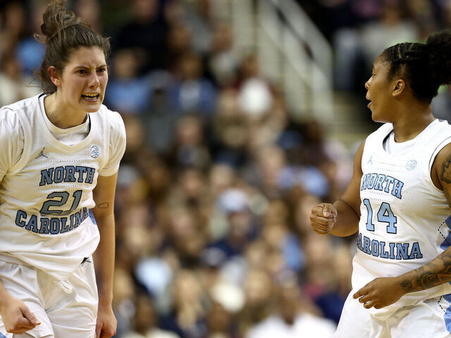 GREENSBORO, NORTH CAROLINA - NOVEMBER 15: Ciera Toomey #21 and Trayanna Crisp #14 of the North Carolina Tar Heels react during the second half of the game against the UConn Huskies at First Horizon Coliseum on November 15, 2024 in Greensboro, North Carolina.