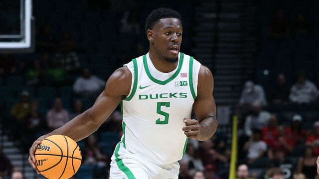 LAS VEGAS, NV - NOVEMBER 26: Oregon Ducks guard TJ Bamba (5) in action against Texas A&M Aggies forward Andersson Garcia (11) during the Players Era Festival on Tuesday, Nov. 26, 2024, at the MGM Grand Garden Arena in Las Vegas, Nevada.