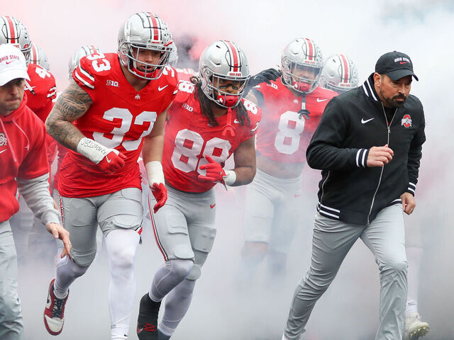 COLUMBUS, OH - NOVEMBER 23: Ohio State Buckeyes defensive end Jack Sawyer (33), tight end Gee Scott Jr. (88) and head coach Ryan Day run onto the field before the game against the Indiana Hoosiers and the Ohio State Buckeyes on November 23, 2024, at Ohio Stadium in Columbus, OH.