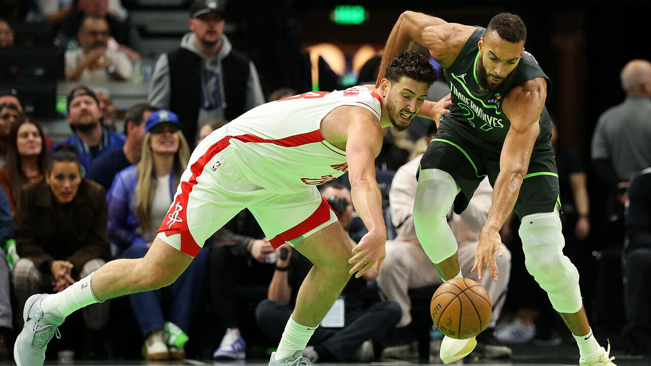 MINNEAPOLIS, MINNESOTA - NOVEMBER 26: Alperen Sengun #28 of the Houston Rockets and Rudy Gobert #27 of the Minnesota Timberwolves compete for the ball in the first quarter during the Emirates NBA Cup at Target Center on November 26, 2024 in Minneapolis, Minnesota.