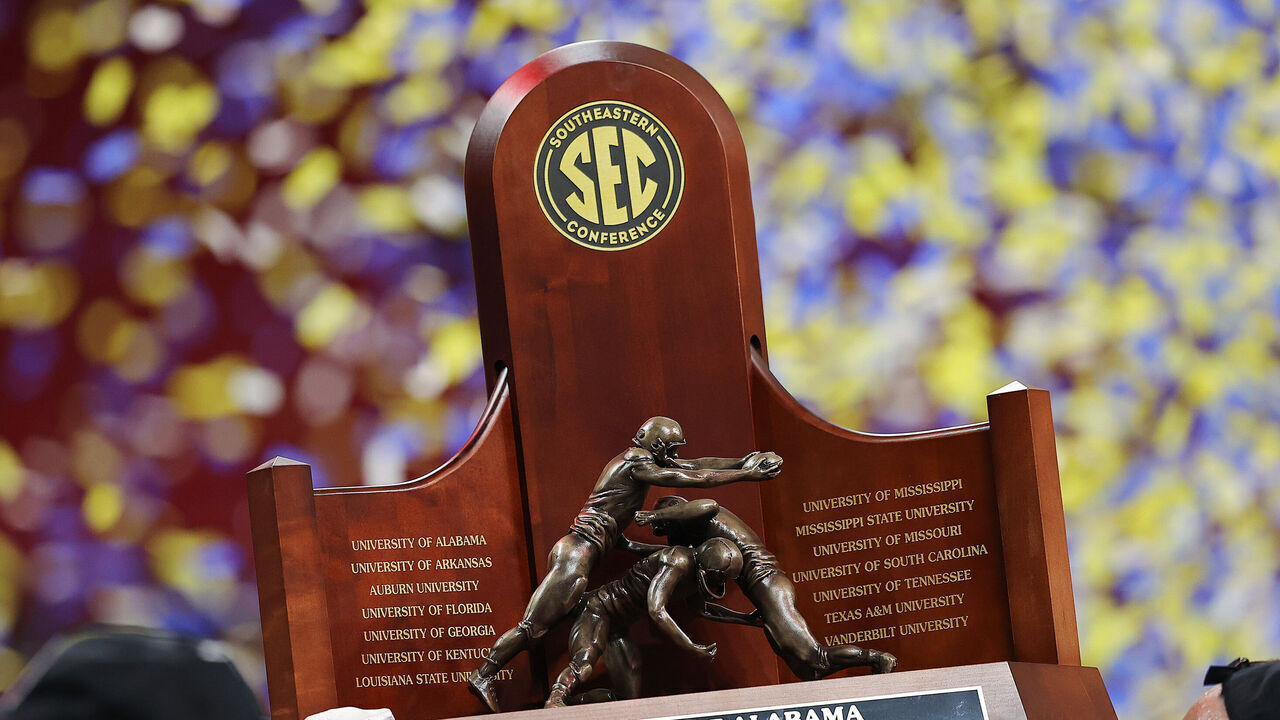 ATLANTA, GEORGIA - DECEMBER 04: The SEC Championship trophy is held after the Alabama Crimson Tide beat the Georgia Bulldogs in the SEC Championship game at Mercedes-Benz Stadium on December 04, 2021 in Atlanta, Georgia.