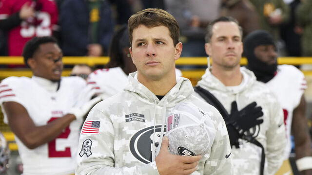 GREEN BAY, WISCONSIN - NOVEMBER 24: Quarterback Brock Purdy #13 of the San Francisco 49ers looks on during the anthem before an NFL football game against the Green Bay Packers at Lambeau Field on November 24, 2024 in Green Bay, Wisconsin.