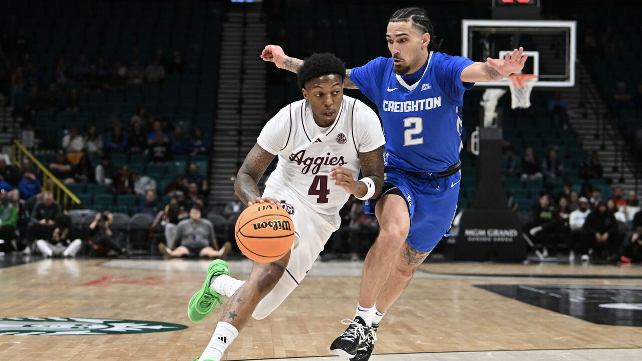 LAS VEGAS, NEVADA - NOVEMBER 27: Wade Taylor IV #4 of the Texas A&M Aggies drives past Pop Isaacs #2 of the Creighton Bluejays in the first half of their game during the Players Era Festival basketball tournament at MGM Grand Garden Arena on November 27, 2024 in Las Vegas, Nevada.