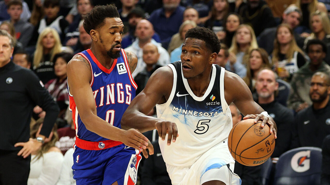 MINNEAPOLIS, MINNESOTA - NOVEMBER 27: Anthony Edwards #5 of the Minnesota Timberwolves drives to the basket against Malik Monk #0 of the Sacramento Kings in the first quarter at Target Center on November 27, 2024 in Minneapolis, Minnesota.