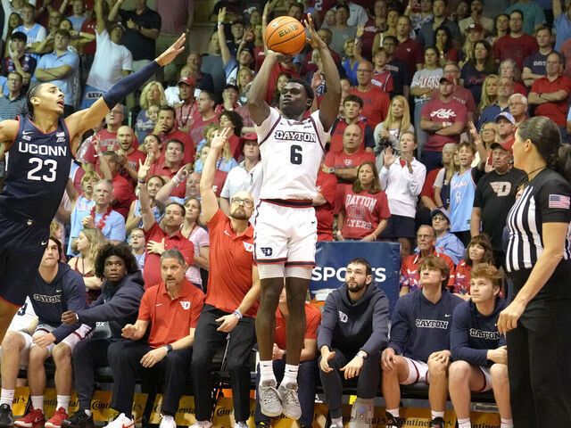 LAHAINA, HI - NOVEMBER 27: Enoch Cheeks #6 of the Dayton Flyers takes a shot over Jayden Ross #23 of the Connecticut Huskies in the second half during a Maui Invitational college basketball game at The Lahaina Civic Center on November 27, 2024 in Lahaina, Hawaii.