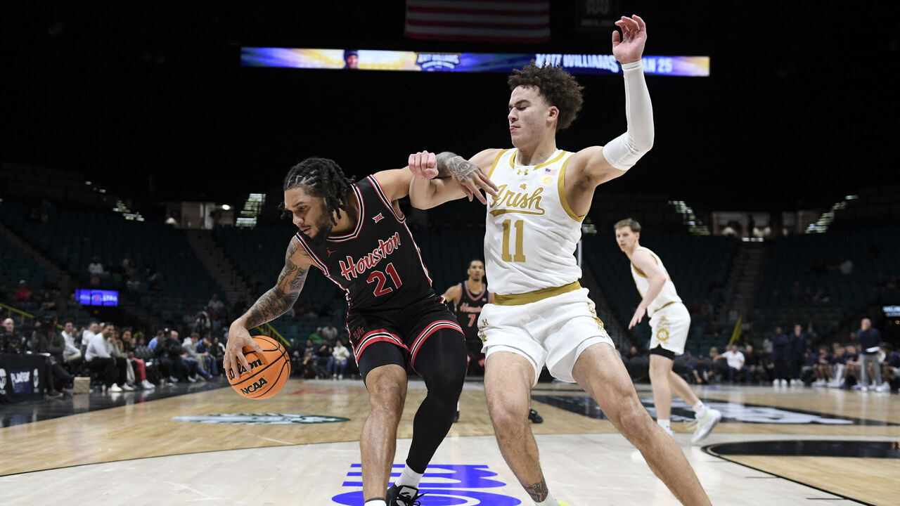 LAS VEGAS, NEVADA - NOVEMBER 27: Emanuel Sharp #21 of the Houston Cougars collides with Braeden Shrewsberry #11 of the Notre Dame Fighting Irish in the second half of their game during the Players Era Festival basketball tournament at MGM Grand Garden Arena on November 27, 2024 in Las Vegas, Nevada. The Cougars defeated the Fighting Irish 65-54.