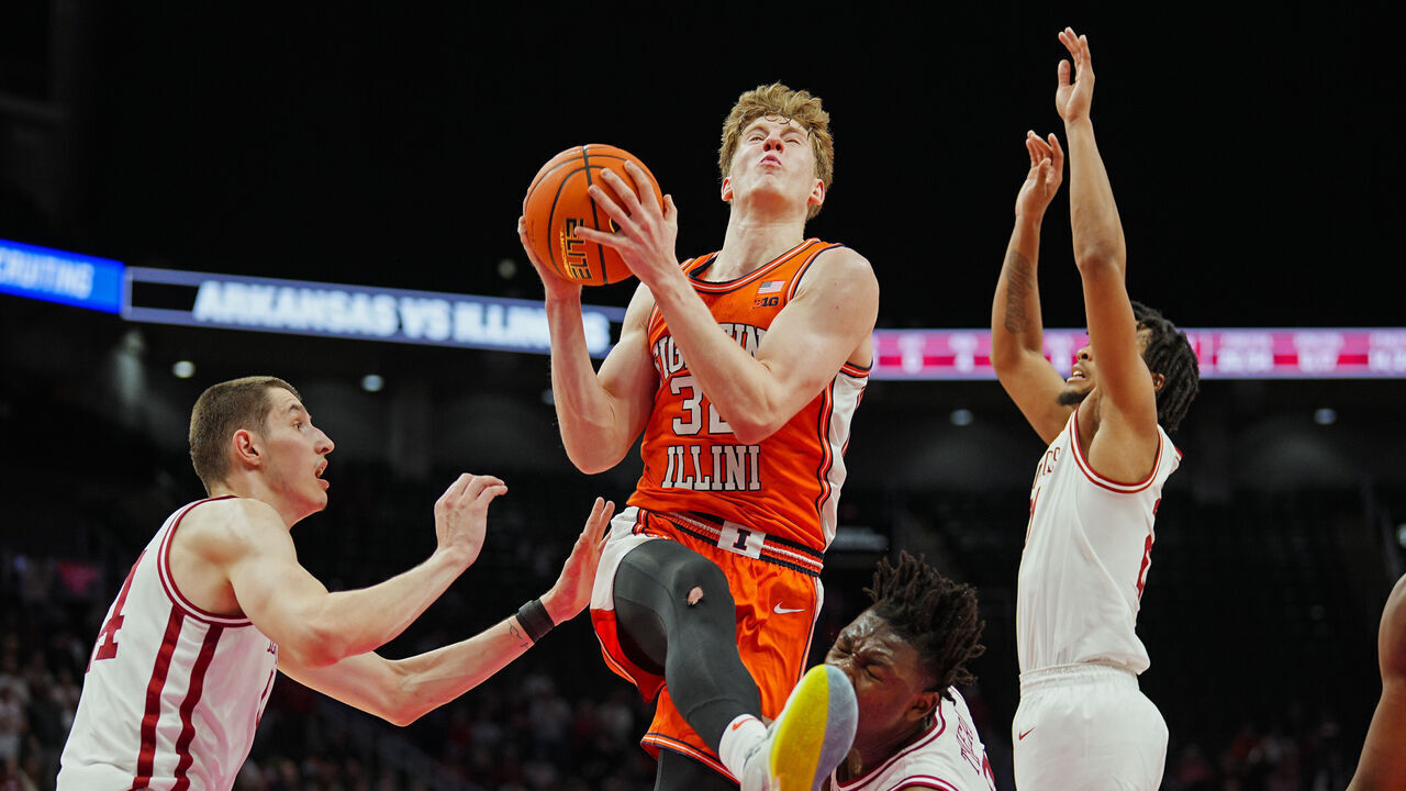 KANSAS CITY, MISSOURI - NOVEMBER 28: Kasparas Jakucionis #32 of the Illinois Fighting Illini goes up for a shot against Zvonimir Ivisic #44 and Adou Thiero #3 of the Arkansas Razorbacks during the second half at T-Mobile Center on November 28, 2024 in Kansas City, Missouri.