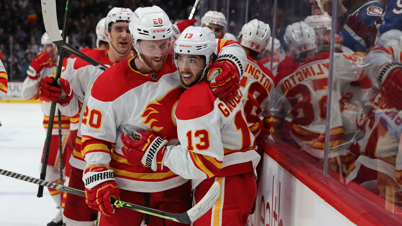DENVER, COLORADO - MARCH 05: Johnny Gaudreau #13 of the Calgary Flames celebrates a game winning goal against the Colorado Avalanche with teammate Blake Coleman #20 at Ball Arena on March 05, 2022 in Denver, Colorado. The Flames defeated the Avalanche 4-3 in overtime.